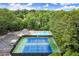 Aerial view of community pool, tennis courts and surrounding trees, offering recreational opportunities at 3545 Turtle Cove Se Ct, Marietta, GA 30067