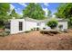 Backyard view showcasing the house with lush landscaping and rock feature at 3545 Turtle Cove Se Ct, Marietta, GA 30067