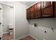 Laundry room featuring brown cabinets and terracotta floors at 3545 Turtle Cove Se Ct, Marietta, GA 30067