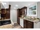 Well-lit kitchen with granite countertops, white appliances, and dark wood cabinetry at 406 Northdale Ct, Lawrenceville, GA 30046