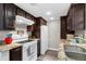 Kitchen featuring granite countertops, stainless steel sink, and dark wood cabinets at 406 Northdale Ct, Lawrenceville, GA 30046