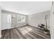 Well-lit living room with gray floors, neutral walls, and ample natural light from the windows at 406 Northdale Ct, Lawrenceville, GA 30046