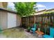 Small patio area with painted chairs, a small table, and a white door leading to the attached storage at 406 Northdale Ct, Lawrenceville, GA 30046