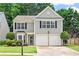 Charming two-story home featuring a manicured lawn, a two-car garage and traditional architectural details at 585 Ashland Pkwy, Woodstock, GA 30189