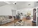 Open-concept living room flows into the kitchen with bar seating and dining area, creating an inviting space at 585 Ashland Pkwy, Woodstock, GA 30189