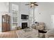 Bright living room featuring high ceilings, a fireplace, and abundant natural light from large windows at 585 Ashland Pkwy, Woodstock, GA 30189