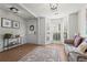 Bright living room featuring hardwood floors, bay windows, decorative lighting, and a comfortable sofa at 585 Ashland Pkwy, Woodstock, GA 30189