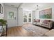 Bright living room with natural light, hardwood floors, a comfortable sofa, and a bay window at 585 Ashland Pkwy, Woodstock, GA 30189