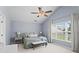 Serene bedroom with vaulted ceilings, a ceiling fan, and large windows that provide abundant natural light at 585 Ashland Pkwy, Woodstock, GA 30189
