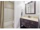 Cozy bathroom featuring a vanity with dark wood cabinets and a shower-tub combination at 650 Garden Wilde Pl, Roswell, GA 30075