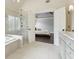 Bright bathroom featuring a glass shower, double vanity, and access to a bedroom at 650 Garden Wilde Pl, Roswell, GA 30075