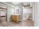 Bathroom with a light wood cabinet and a large mirror at 650 Garden Wilde Pl, Roswell, GA 30075