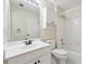 Bright bathroom featuring white tile, white cabinets, and a shower-tub combo at 650 Garden Wilde Pl, Roswell, GA 30075