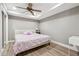 Bedroom with hardwood floors, a fan, and a bed at 650 Garden Wilde Pl, Roswell, GA 30075