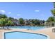 Community pool area with a large swimming pool and lounge chairs for relaxation at 650 Garden Wilde Pl, Roswell, GA 30075