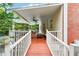 Covered deck with outdoor seating, perfect for enjoying the serene backyard view at 650 Garden Wilde Pl, Roswell, GA 30075