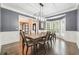 Elegant dining room with wainscoting, a modern chandelier, and bright bay windows at 650 Garden Wilde Pl, Roswell, GA 30075