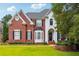 Beautiful two-story brick home featuring manicured landscaping and inviting front entrance at 650 Garden Wilde Pl, Roswell, GA 30075