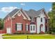 Charming brick home featuring manicured lawn, black shutters and white trim at 650 Garden Wilde Pl, Roswell, GA 30075