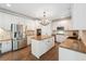 Bright kitchen features stainless appliances, granite countertops and white cabinetry at 650 Garden Wilde Pl, Roswell, GA 30075