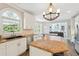 Modern kitchen with granite countertops, stainless steel appliances, and a bright chandelier at 650 Garden Wilde Pl, Roswell, GA 30075
