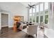 Inviting living room with tall windows, hardwood floors, and an open concept layout at 650 Garden Wilde Pl, Roswell, GA 30075