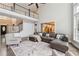 Open-concept living space featuring a high ceiling, hardwood floors, and a cozy leather sectional sofa at 650 Garden Wilde Pl, Roswell, GA 30075