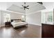 Spacious main bedroom suite featuring a tray ceiling, hardwood floors and an abundance of natural light at 650 Garden Wilde Pl, Roswell, GA 30075
