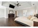 Serene main bedroom with tray ceilings, hardwood floors, and an ensuite bathroom entrance at 650 Garden Wilde Pl, Roswell, GA 30075