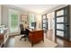 Home office with a built-in desk, decorative door, and bright natural light at 650 Garden Wilde Pl, Roswell, GA 30075