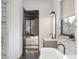 Modern bathroom with marble accents, stylish fixtures, and a view into the main bedroom at 13375 Fincher Rd, Canton, GA 30114