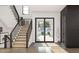 Staircase in entry hall featuring iron railings, wood stairs, and view to front yard at 13375 Fincher Rd, Canton, GA 30114