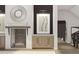 A modern fireplace with a decorative sunburst mirror and built-in cabinetry adds a focal point to the space at 13375 Fincher Rd, Canton, GA 30114