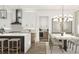 View of the kitchen, island, and dining area featuring modern finishes and stylish lighting at 13375 Fincher Rd, Canton, GA 30114