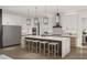 Bright kitchen with white cabinetry, stainless steel appliances, a large island, and pendant lighting at 13375 Fincher Rd, Canton, GA 30114