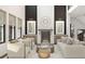 An open-concept living room showcases a fireplace, modern furniture, and an abundance of natural light at 13375 Fincher Rd, Canton, GA 30114