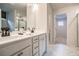 Stylish bathroom with double sink vanity and view to the glass shower and the door to a bedroom at 2038 Brookhill Way Lot 6, Snellville, GA 30078