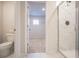 Bathroom view to closet, featuring a modern shower, tile flooring, and walk-in closet at 2038 Brookhill Way Lot 6, Snellville, GA 30078