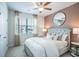 Modern bedroom features a stylish accent wall, natural light, and a ceiling fan at 2038 Brookhill Way Lot 6, Snellville, GA 30078
