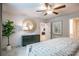 Bedroom with dark dresser, round mirror, artwork, and a ceiling fan, offering a cozy and stylish retreat at 2038 Brookhill Way Lot 6, Snellville, GA 30078
