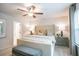 Comfortable bedroom features a tufted headboard, neutral decor, ceiling fan, and a bright window view at 2038 Brookhill Way Lot 6, Snellville, GA 30078