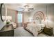 Cozy bedroom features a charming rainbow wall art, soft textures, and a ceiling fan for added comfort at 2038 Brookhill Way Lot 6, Snellville, GA 30078