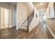 Hallway with wood-look flooring, leading to the staircase and featuring two doors on the side at 2038 Brookhill Way Lot 6, Snellville, GA 30078