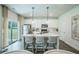 Modern kitchen featuring stainless steel appliances, white cabinets, and a central island with seating at 2038 Brookhill Way Lot 6, Snellville, GA 30078