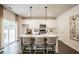 Eat-in kitchen features a center island with seating, pendant lights, and stainless steel appliances at 2038 Brookhill Way Lot 6, Snellville, GA 30078