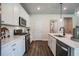 Well-equipped kitchen boasts white cabinetry, stainless steel appliances, and sleek countertops at 2038 Brookhill Way Lot 6, Snellville, GA 30078