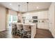 Kitchen with an island and barstool seating, modern appliances, and access to the backyard at 2038 Brookhill Way Lot 6, Snellville, GA 30078