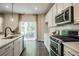 Modern kitchen featuring stainless steel appliances, white cabinets, and a sliding glass door to a patio at 2038 Brookhill Way Lot 6, Snellville, GA 30078