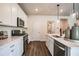 Modern kitchen featuring stainless steel appliances, white cabinets, tile backsplash, and quartz countertops at 2038 Brookhill Way Lot 6, Snellville, GA 30078