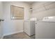 Functional laundry area features a washer, dryer, wire shelving, and stylish decor for added convenience at 2038 Brookhill Way Lot 6, Snellville, GA 30078